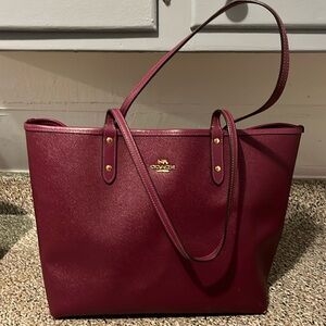 Coach women’s purse maroon and color.